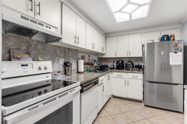 kitchen with stone countertops, white cabinetry, sink, light tile patterned floors, and white appliances