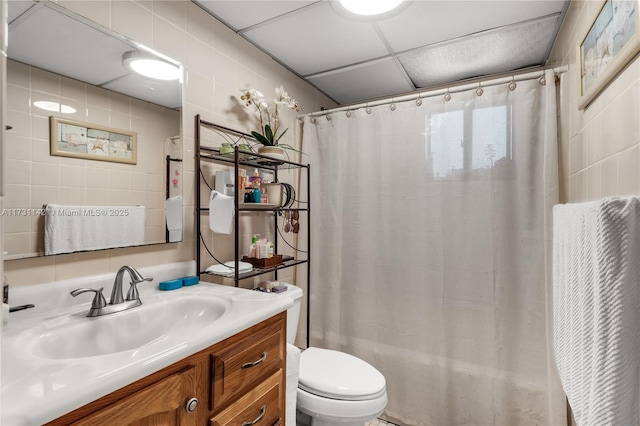 full bathroom with vanity, a paneled ceiling, toilet, and shower / bathtub combination with curtain