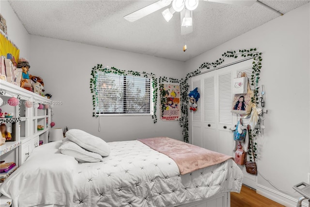 bedroom featuring a textured ceiling, a closet, ceiling fan, and hardwood / wood-style flooring