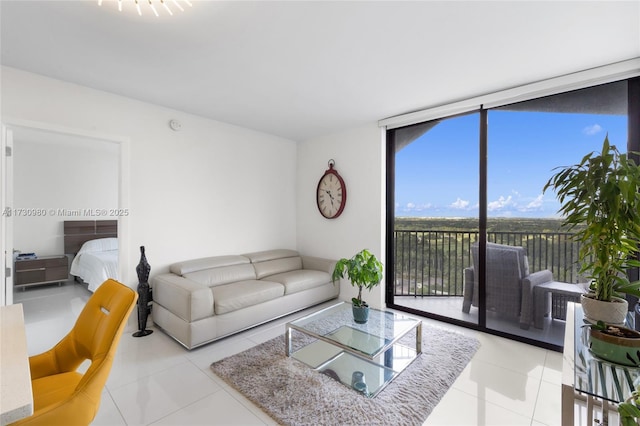 living room featuring a wall of windows and light tile patterned floors