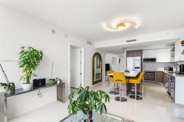 tiled dining room featuring sink