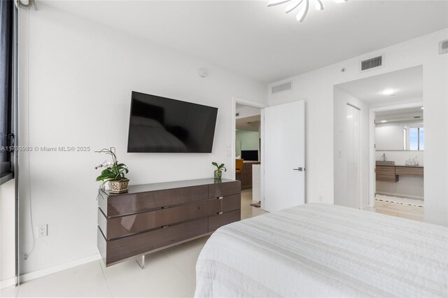 tiled bedroom with ensuite bath