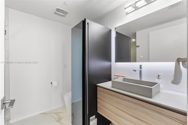 bathroom with vanity and toilet