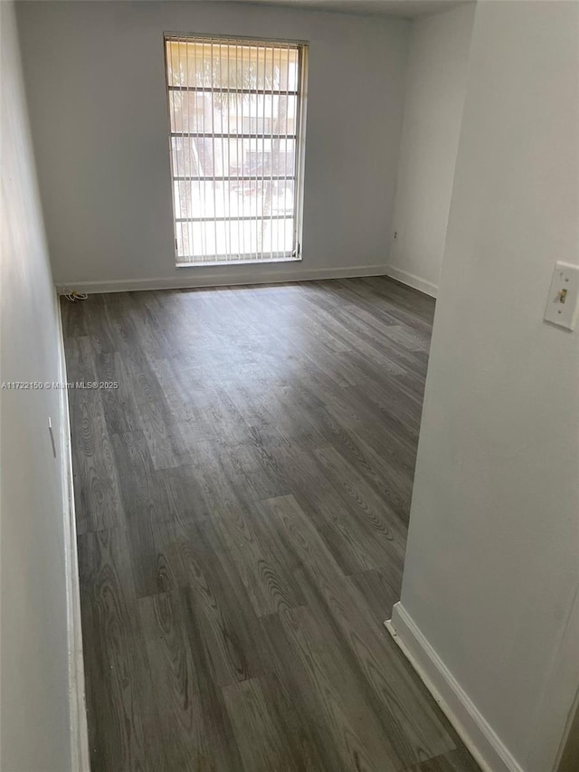 empty room featuring dark wood-type flooring