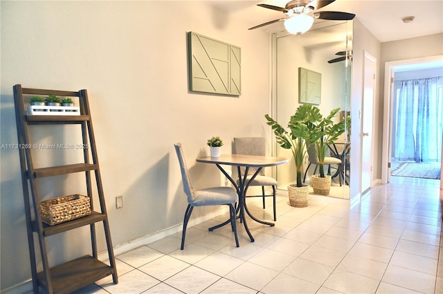 tiled dining space with ceiling fan