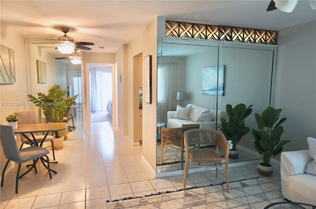 sitting room with light tile patterned flooring and ceiling fan