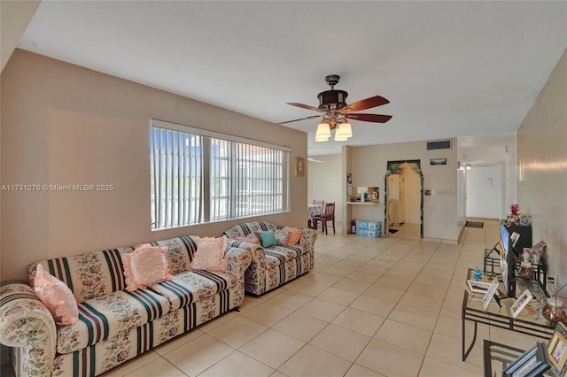 living room featuring light tile patterned floors and ceiling fan