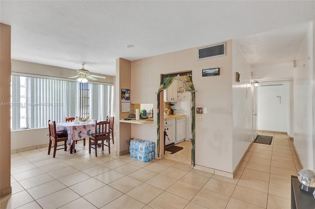 dining area with light tile patterned floors and ceiling fan