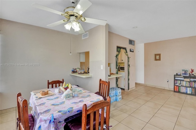 tiled dining space featuring ceiling fan