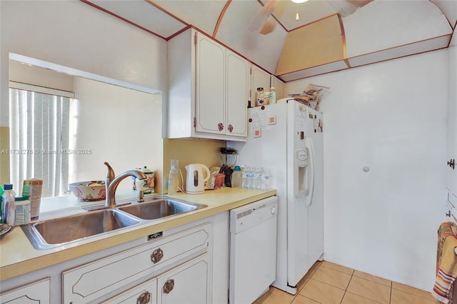 kitchen featuring lofted ceiling, sink, white cabinetry, white dishwasher, and light tile patterned flooring