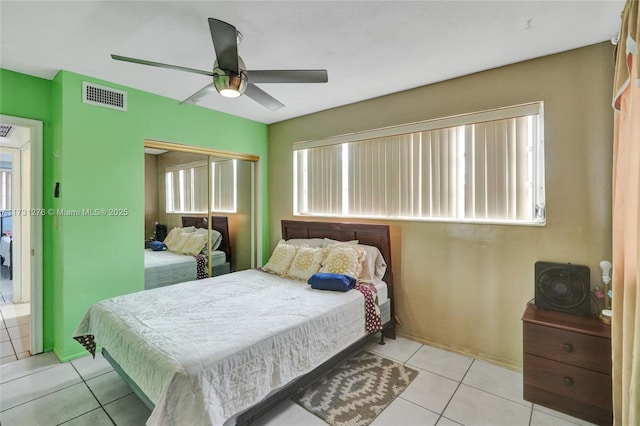 tiled bedroom featuring ceiling fan