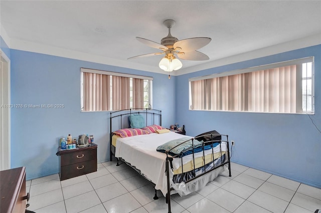 bedroom with ceiling fan and light tile patterned flooring