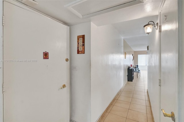 hall featuring light tile patterned floors