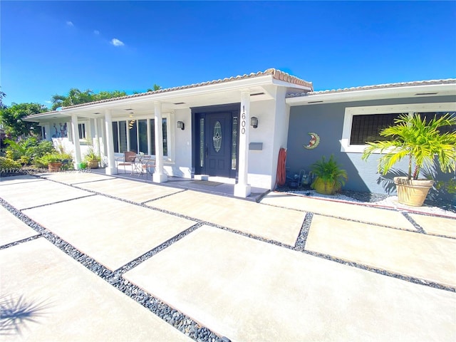 mediterranean / spanish-style house with covered porch