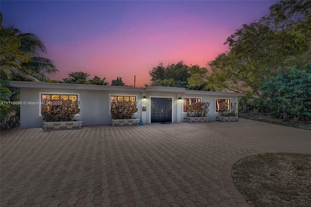 view of front of property with a patio area and stucco siding