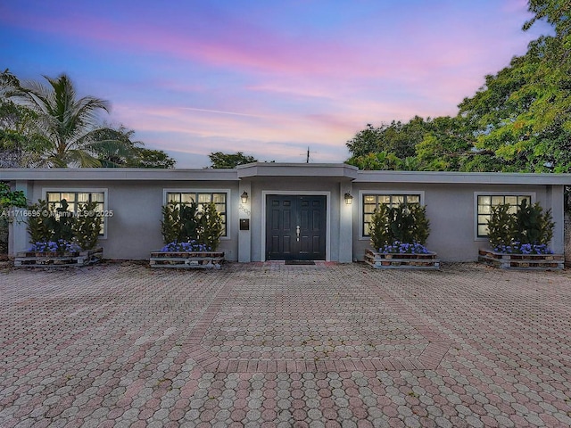 exterior space featuring a patio area and stucco siding