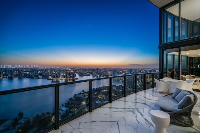 18555 Collins Ave Unit 4203, Sunny Isles Beach, FL 33160 - balcony at dusk featuring a view of city and a water view
