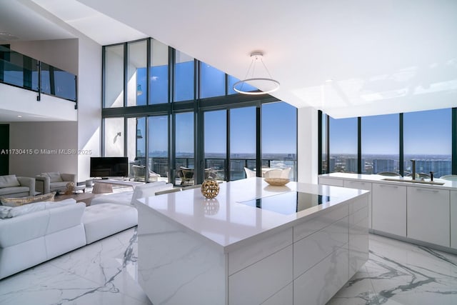 18555 Collins Ave Unit 4203, Sunny Isles Beach, FL 33160 - living room featuring light marble finish floors, a wall of windows, and a high ceiling