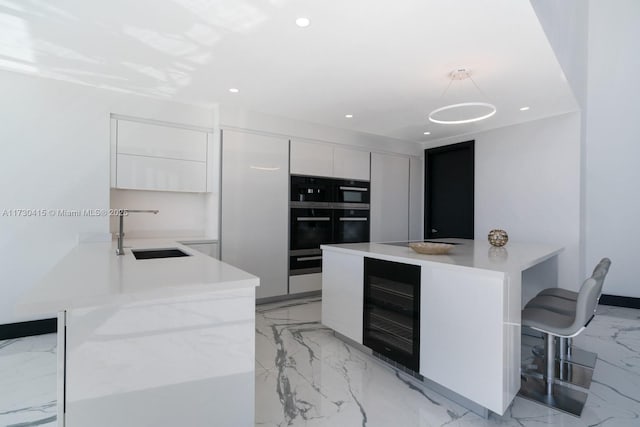 18555 Collins Ave Unit 4203, Sunny Isles Beach, FL 33160 - kitchen featuring modern cabinets, beverage cooler, white cabinetry, light countertops, and light marble finish flooring