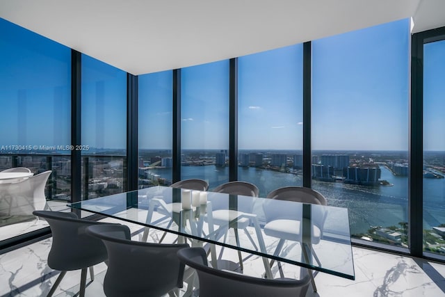 18555 Collins Ave Unit 4203, Sunny Isles Beach, FL 33160 - dining room featuring expansive windows, marble tiled flooring, a view of city, and a water view