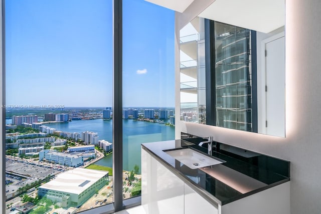 18555 Collins Ave Unit 4203, Sunny Isles Beach, FL 33160 - bathroom with a view of city, a water view, vanity, and expansive windows