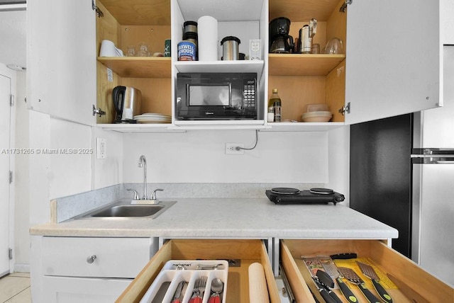 kitchen featuring sink and light tile patterned floors