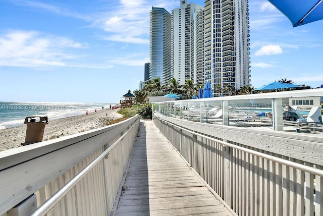 view of home's community featuring a water view and a beach view