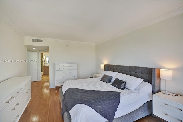 bedroom with crown molding and hardwood / wood-style floors