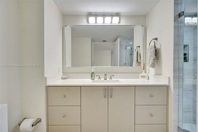 bathroom with vanity and a shower with shower door