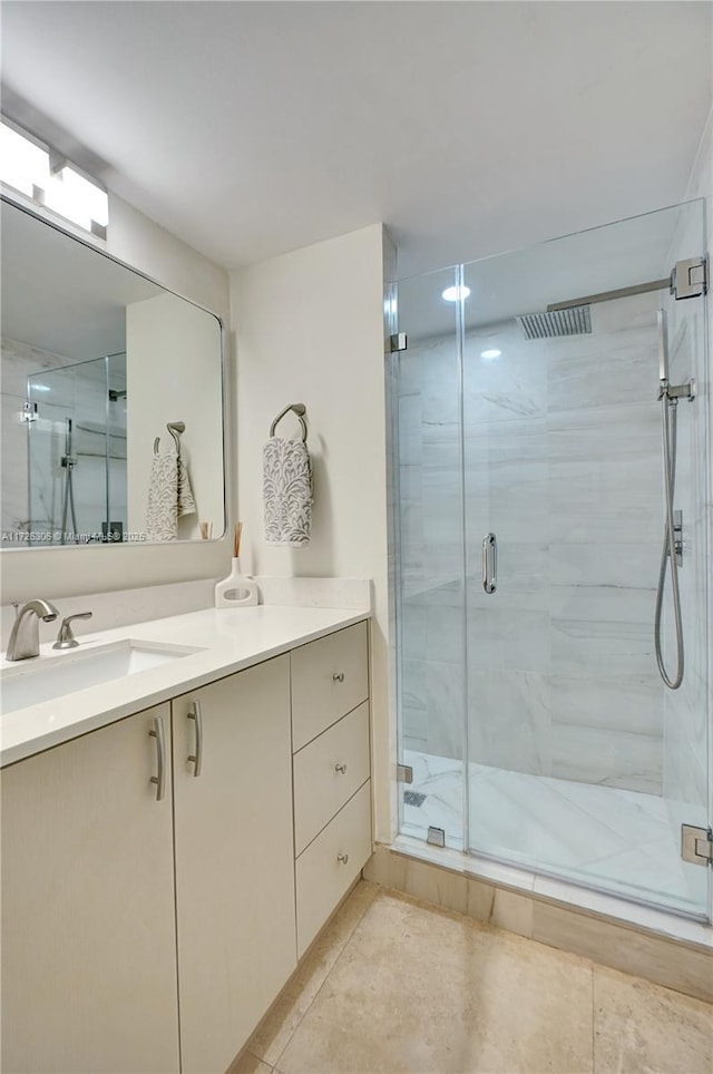 bathroom with vanity, an enclosed shower, and tile patterned flooring