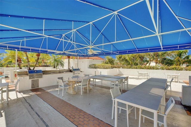 view of patio with area for grilling and a grill