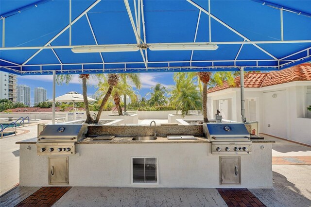 view of patio / terrace with grilling area, exterior kitchen, and sink