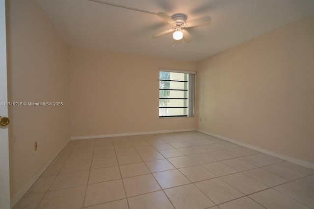 spare room featuring light tile patterned flooring and ceiling fan