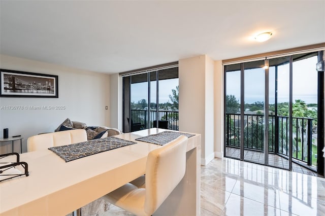 dining space featuring floor to ceiling windows