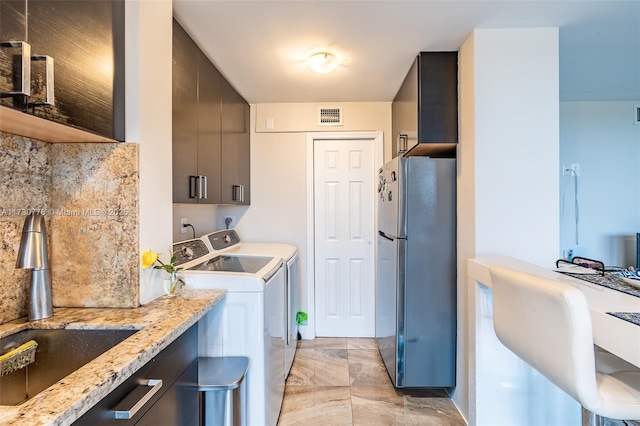 laundry room featuring sink and washing machine and dryer