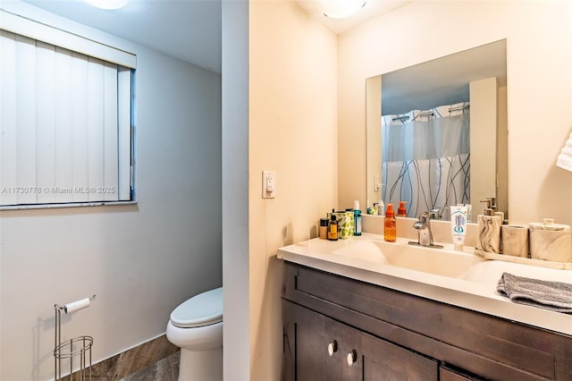 bathroom featuring hardwood / wood-style flooring, vanity, and toilet