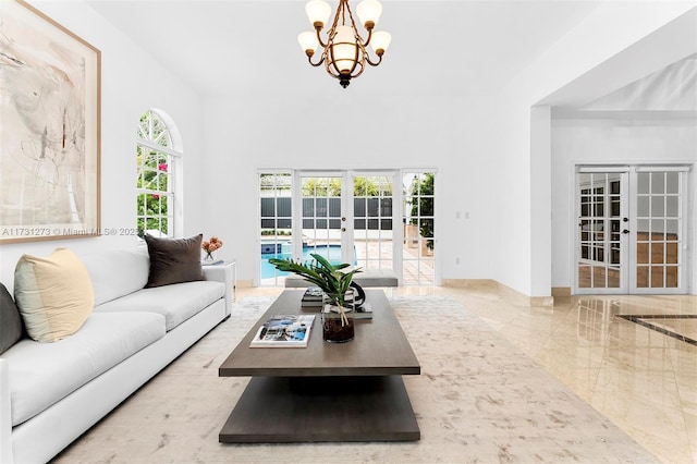 living room with french doors and a chandelier