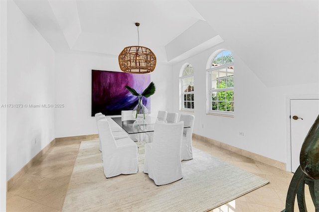 tiled dining area with lofted ceiling