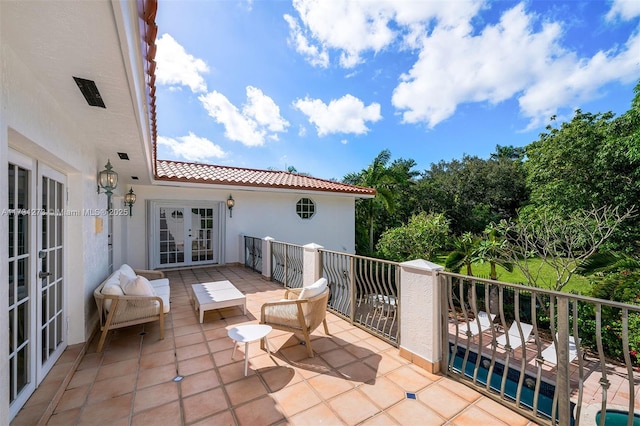 view of patio with a balcony and french doors