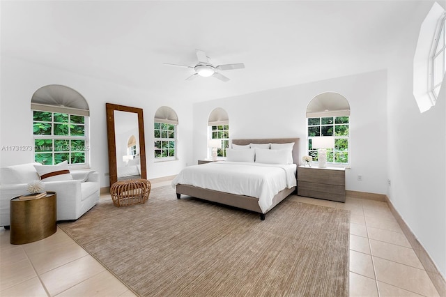 tiled bedroom with ceiling fan