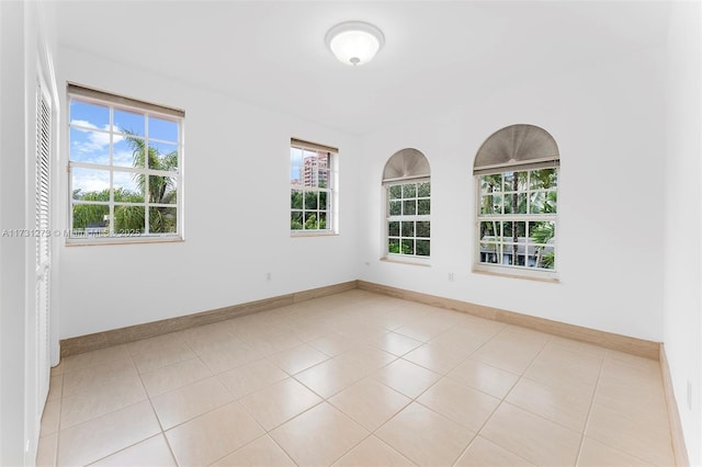 tiled spare room with plenty of natural light