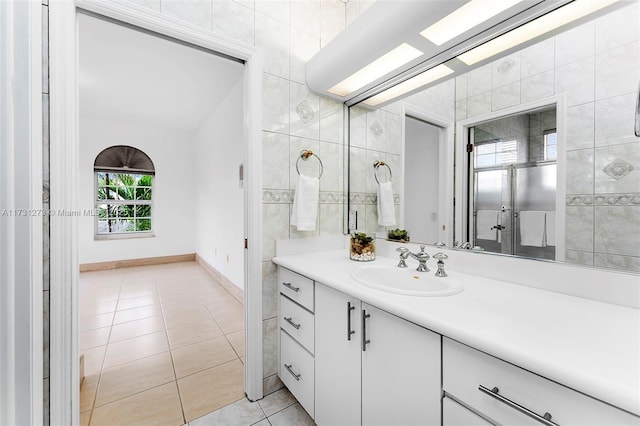 bathroom with vanity, tile patterned floors, and tile walls