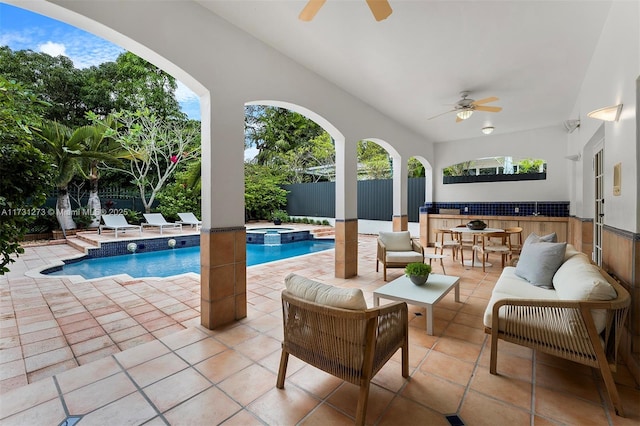 view of pool with an outdoor bar, ceiling fan, a patio, an outdoor living space, and an in ground hot tub