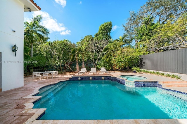 view of pool featuring an in ground hot tub and a patio