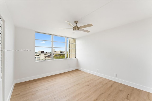 empty room featuring light hardwood / wood-style flooring and ceiling fan