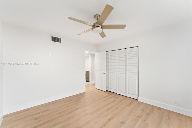 unfurnished bedroom featuring light hardwood / wood-style flooring, ceiling fan, and a closet