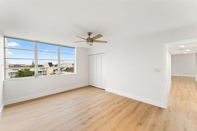 unfurnished room featuring light hardwood / wood-style flooring and ceiling fan