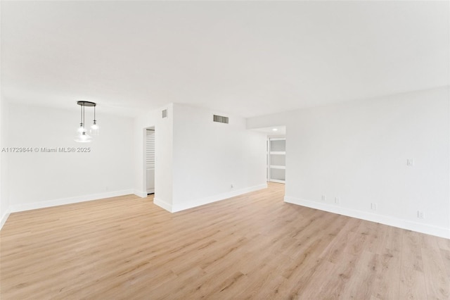 spare room featuring light wood-type flooring