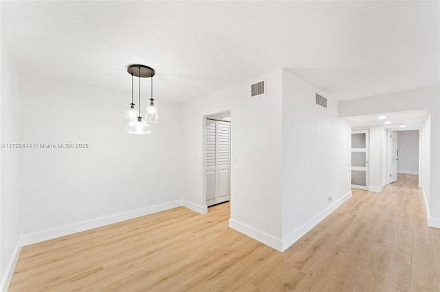 unfurnished room with light hardwood / wood-style flooring