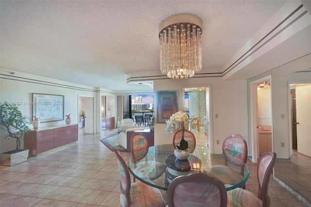 tiled dining area featuring a textured ceiling and an inviting chandelier